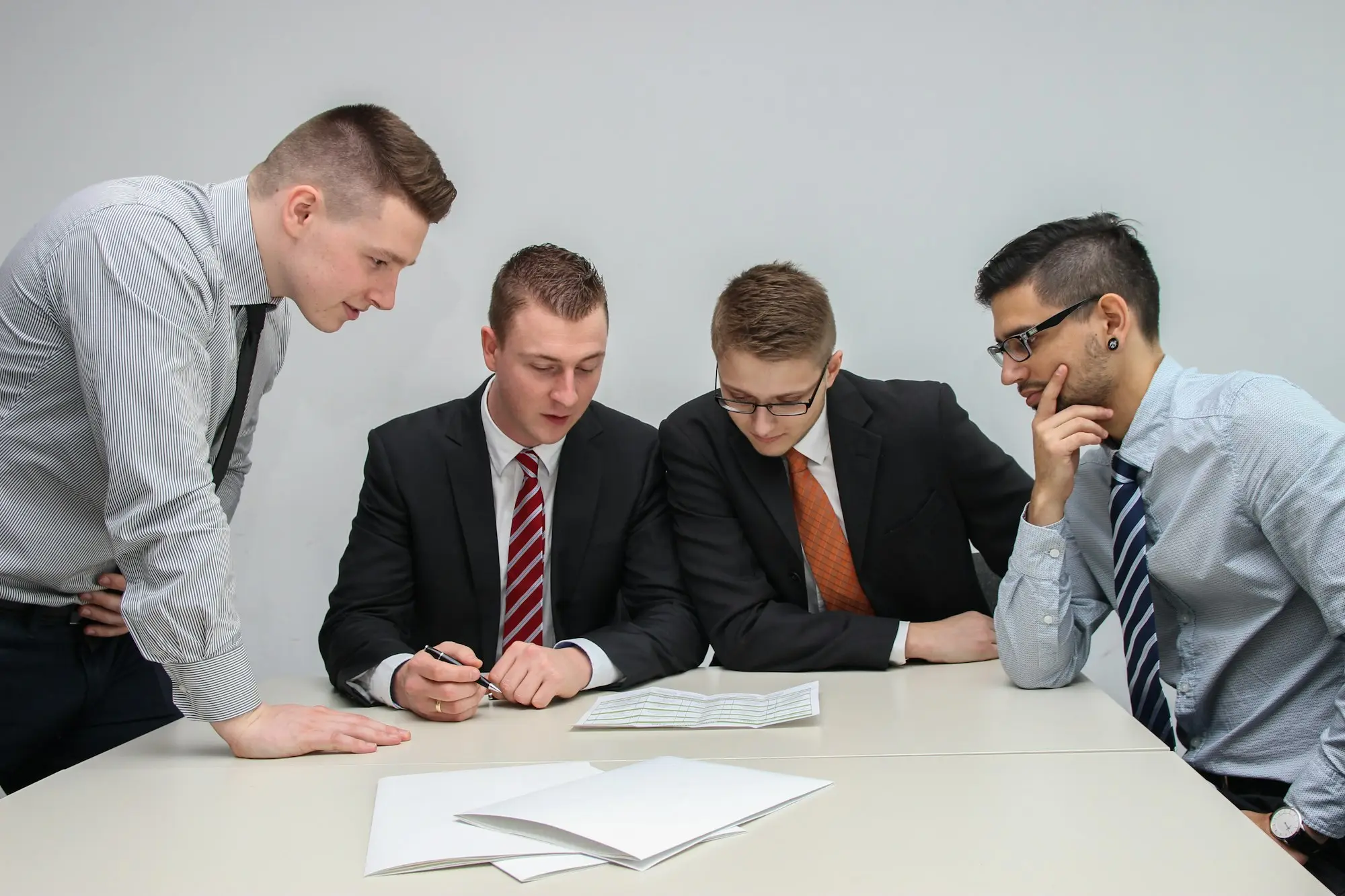 Business owners discussing figures with a finance specialist in a meeting room