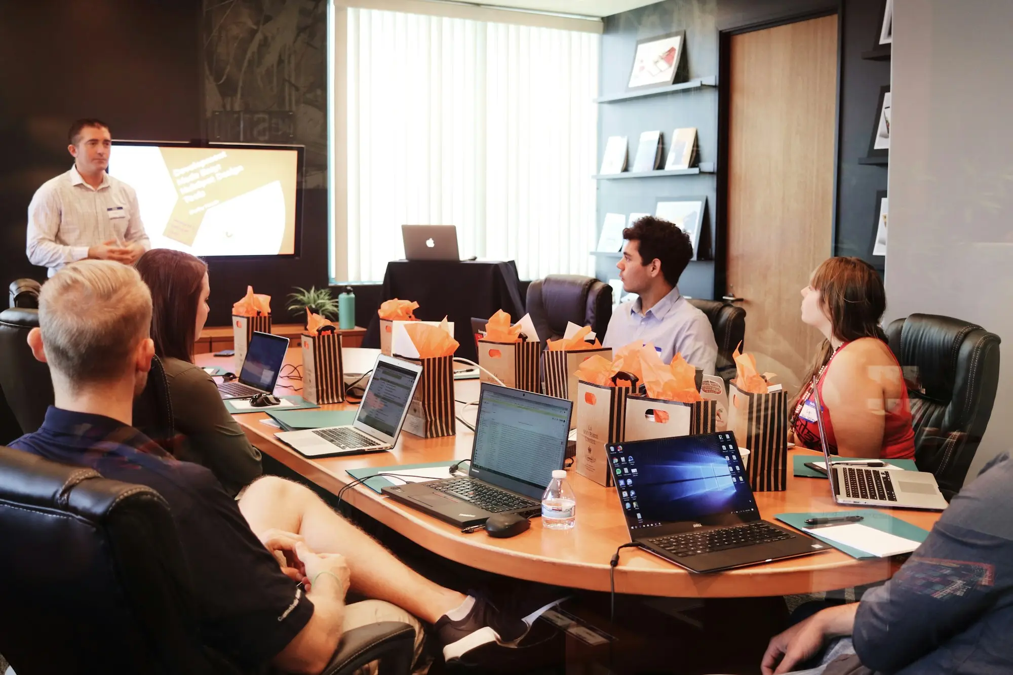Small business team in a marketing budget meeting with laptops